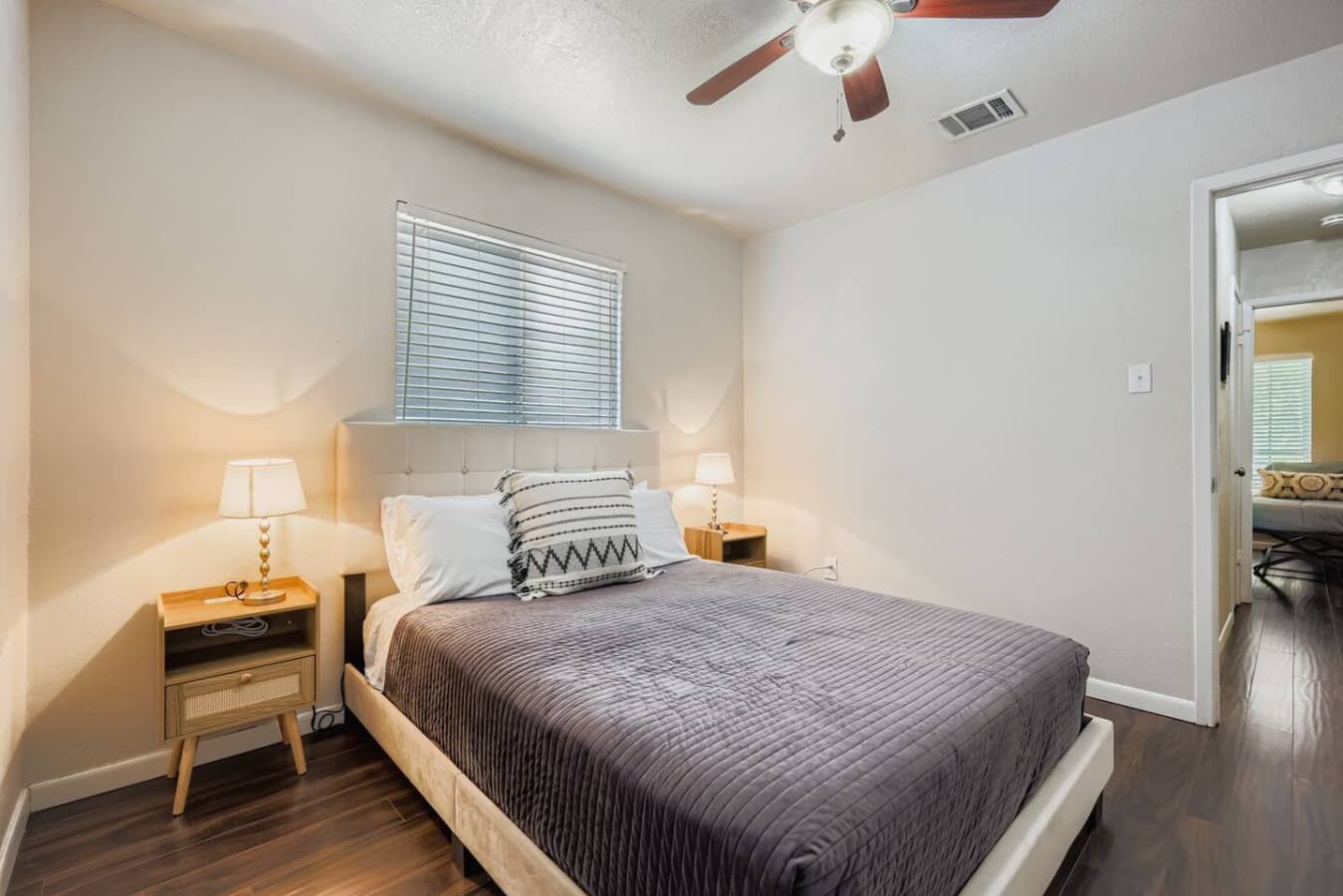 Second bedroom featuring queen size bed.