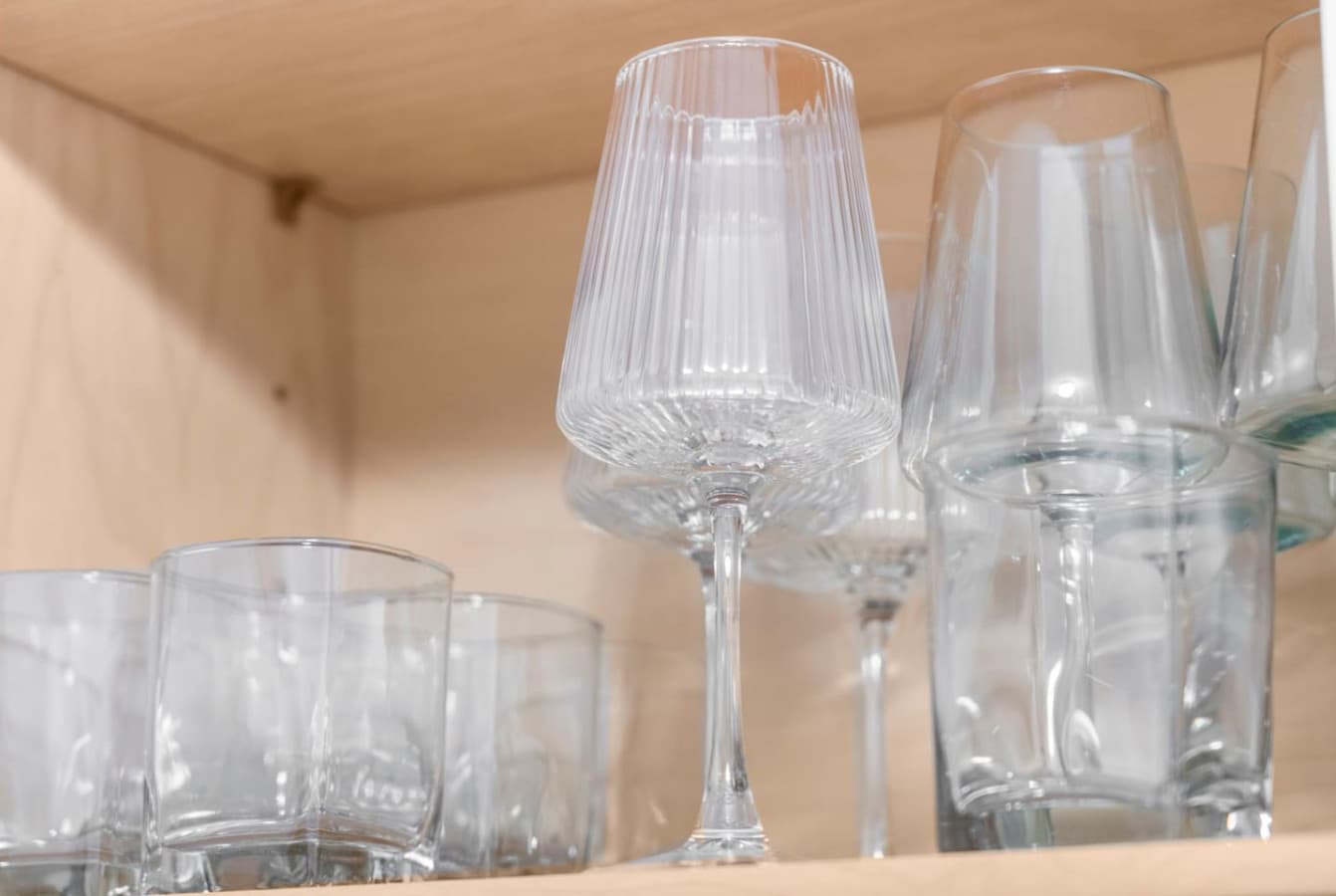 Glassware set neatly stocked and ready for guest use.
