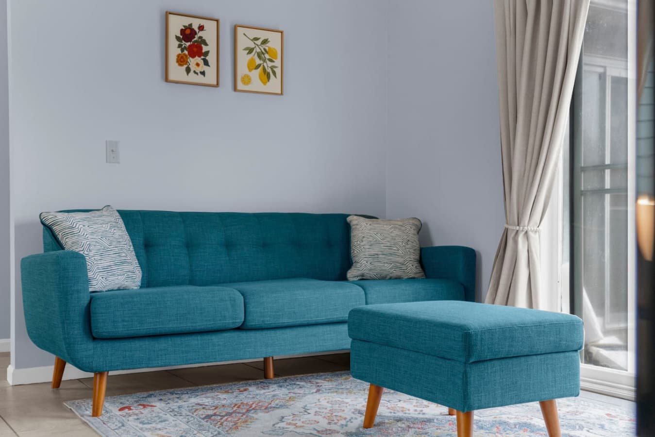Modern teal sofa and ottoman adding a pop of color to the space.