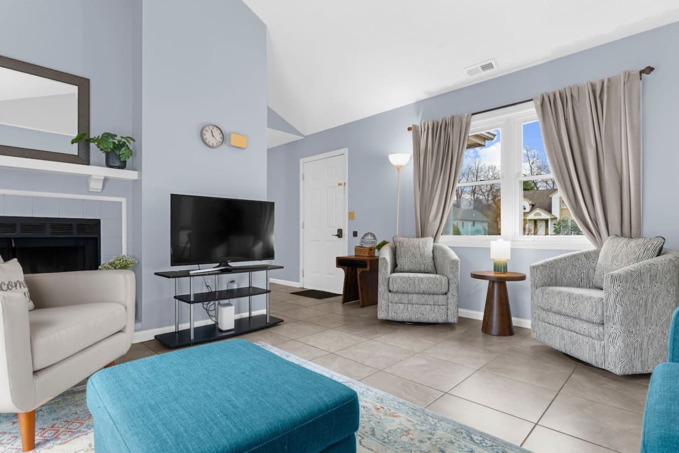 Bright living room with comfortable seating and a TV.