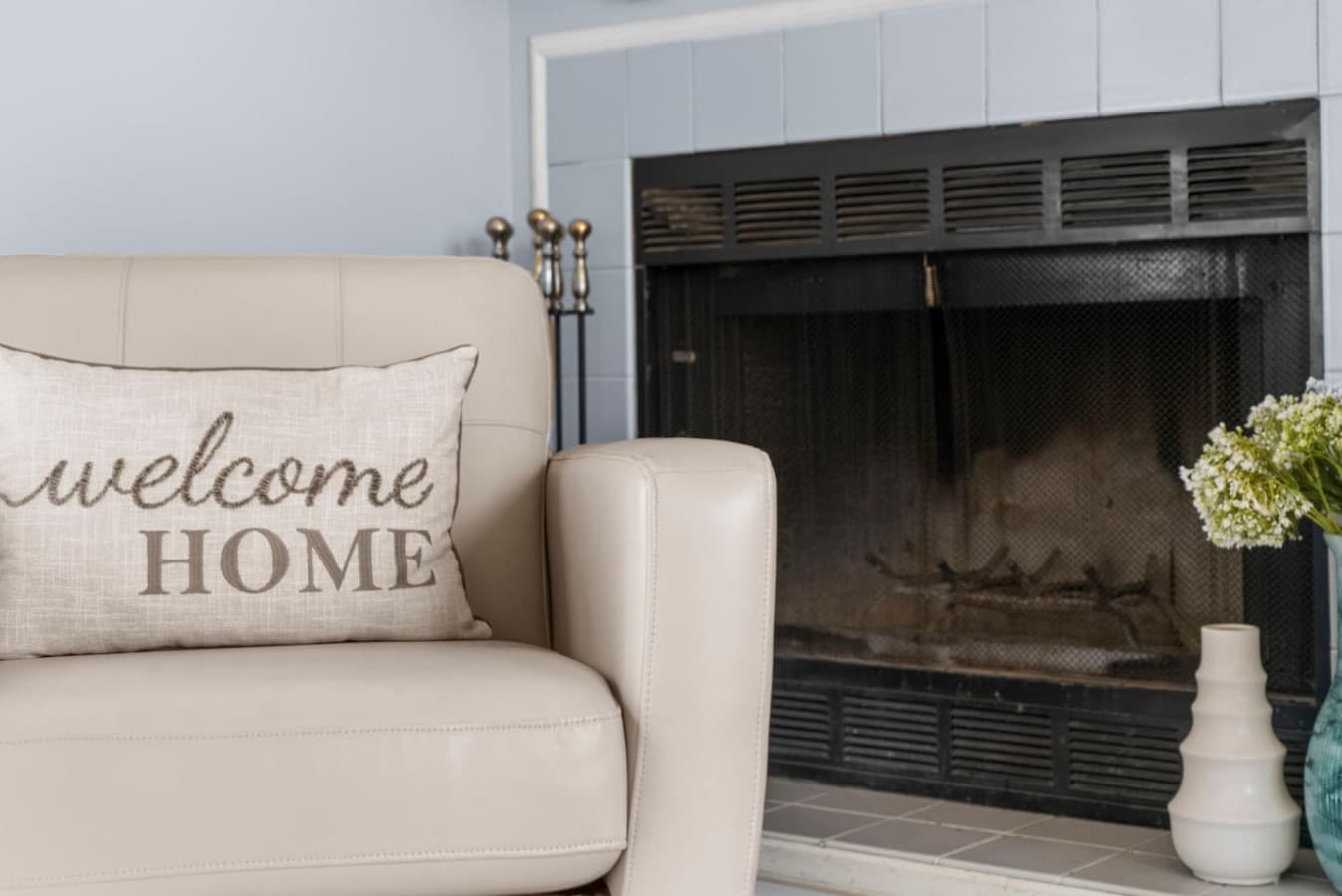 Close view of the fireplace and welcoming accent chair.