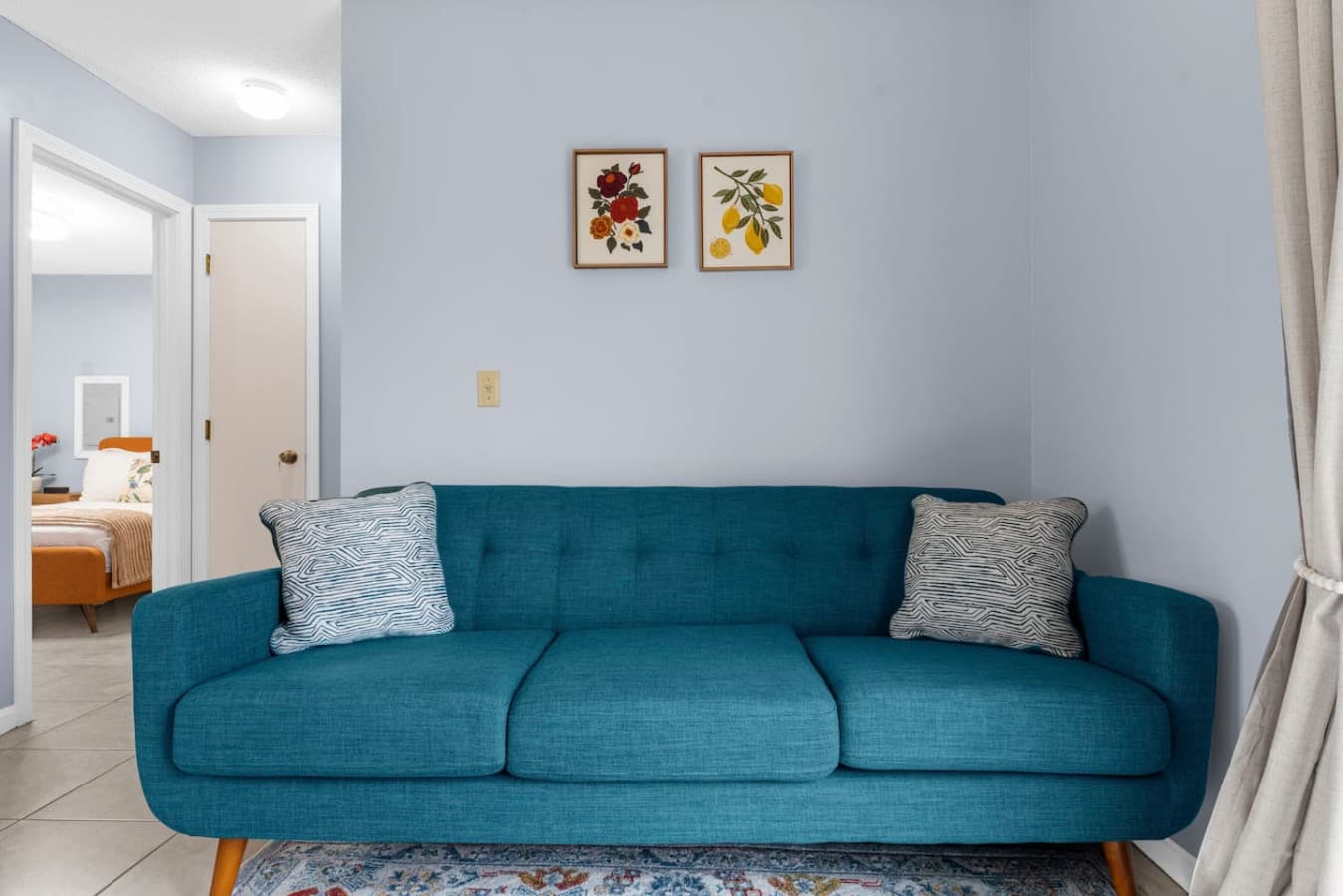 Teal sofa offering a cozy place to relax.