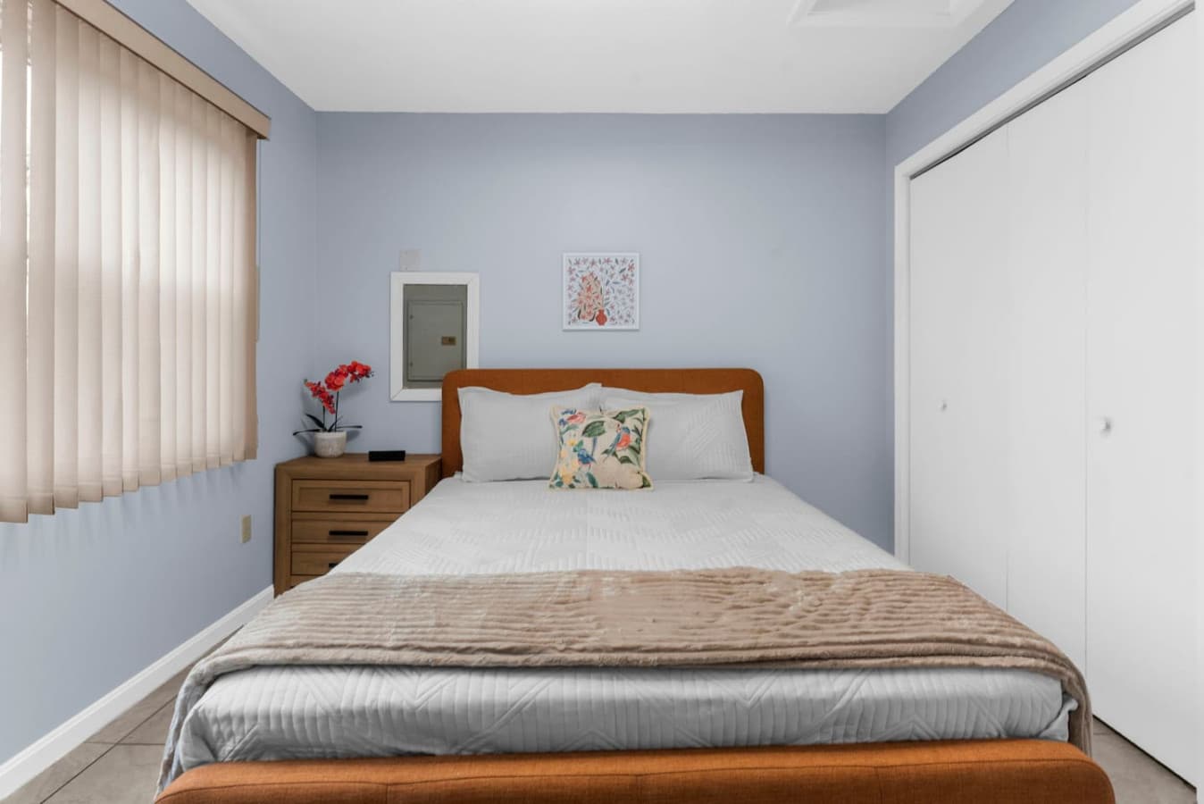 Clean and calming room with plenty of light and storage space.