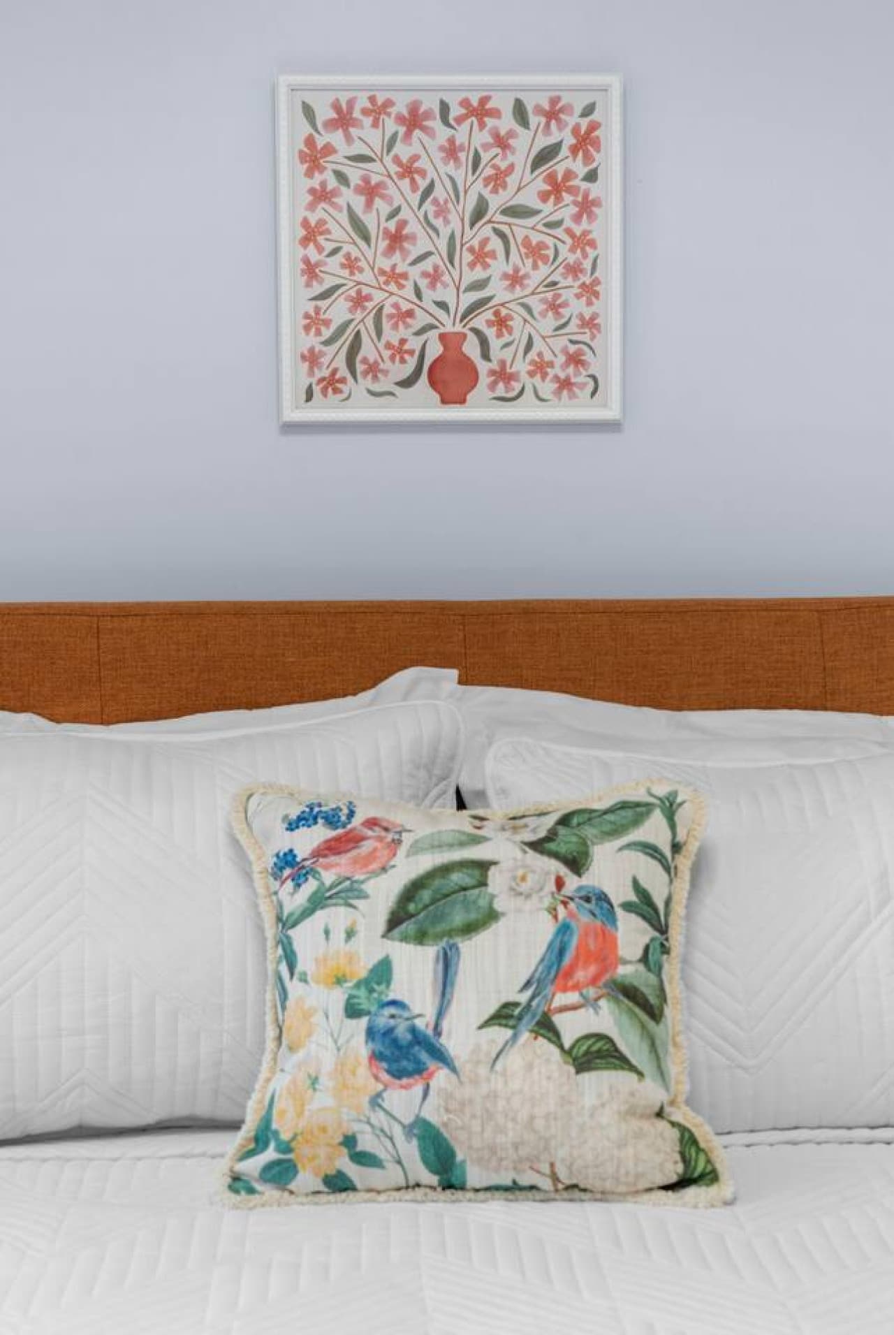 Close view of the pillows and artwork adding a colorful touch.