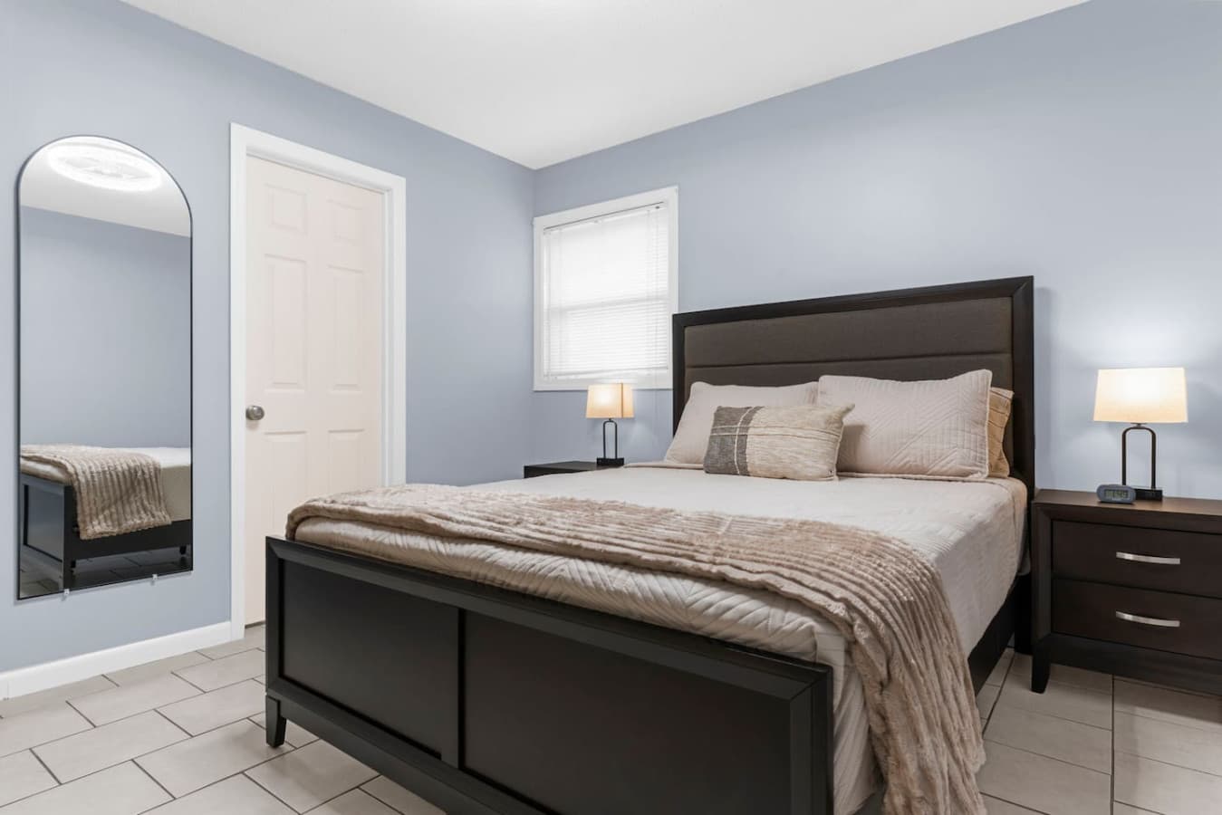 Comfortable bedroom with a large bed and soft neutral tones.