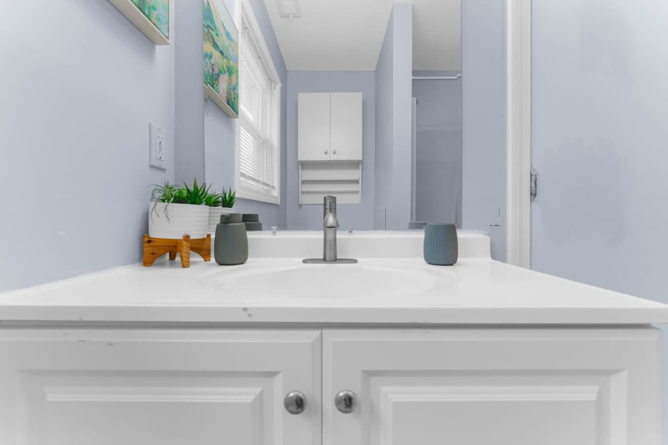 Clean bathroom vanity with fresh towels and simple décor.