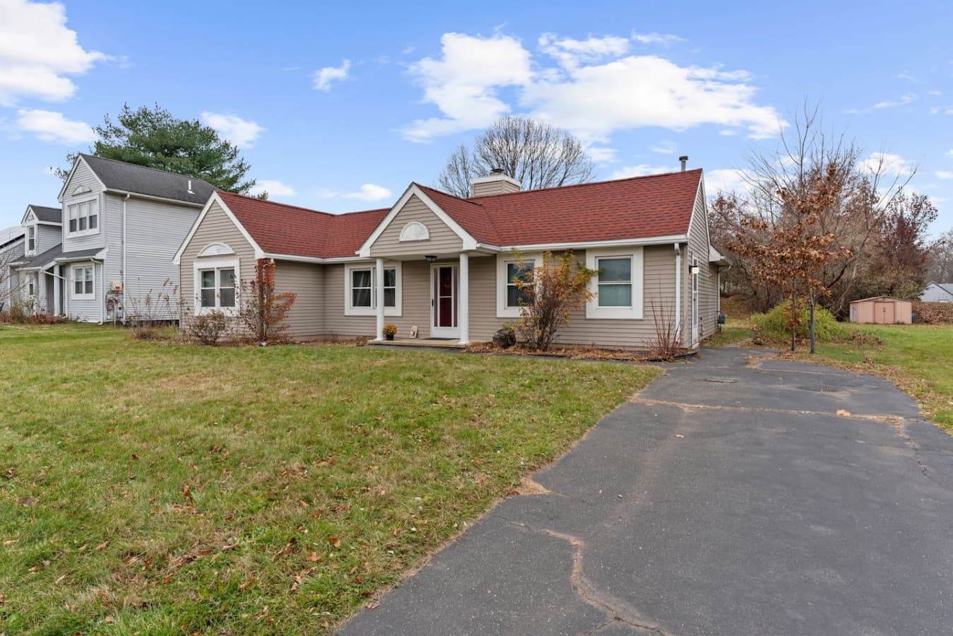 Front view of the home with a spacious yard and driveway.