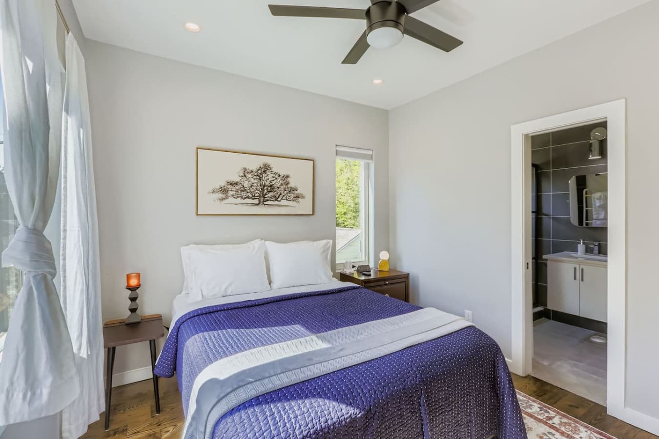 Relax in the serene master bedroom featuring a cozy queen bed, Smart TV and ceiling fan.