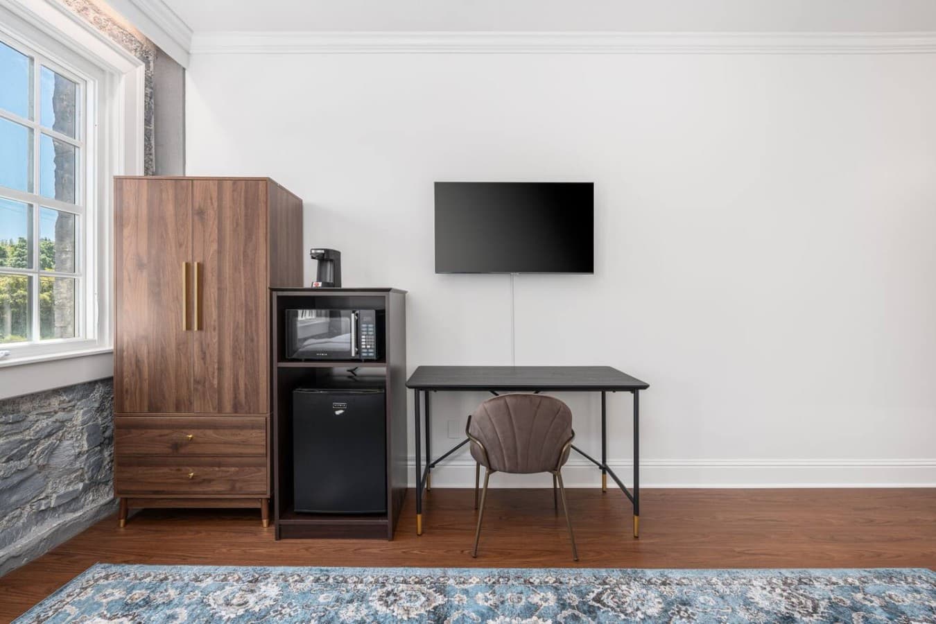 This is the private room you will be renting featuring a workspace, mounted TV, and an in-room microwave and mini fridge for added convenience.