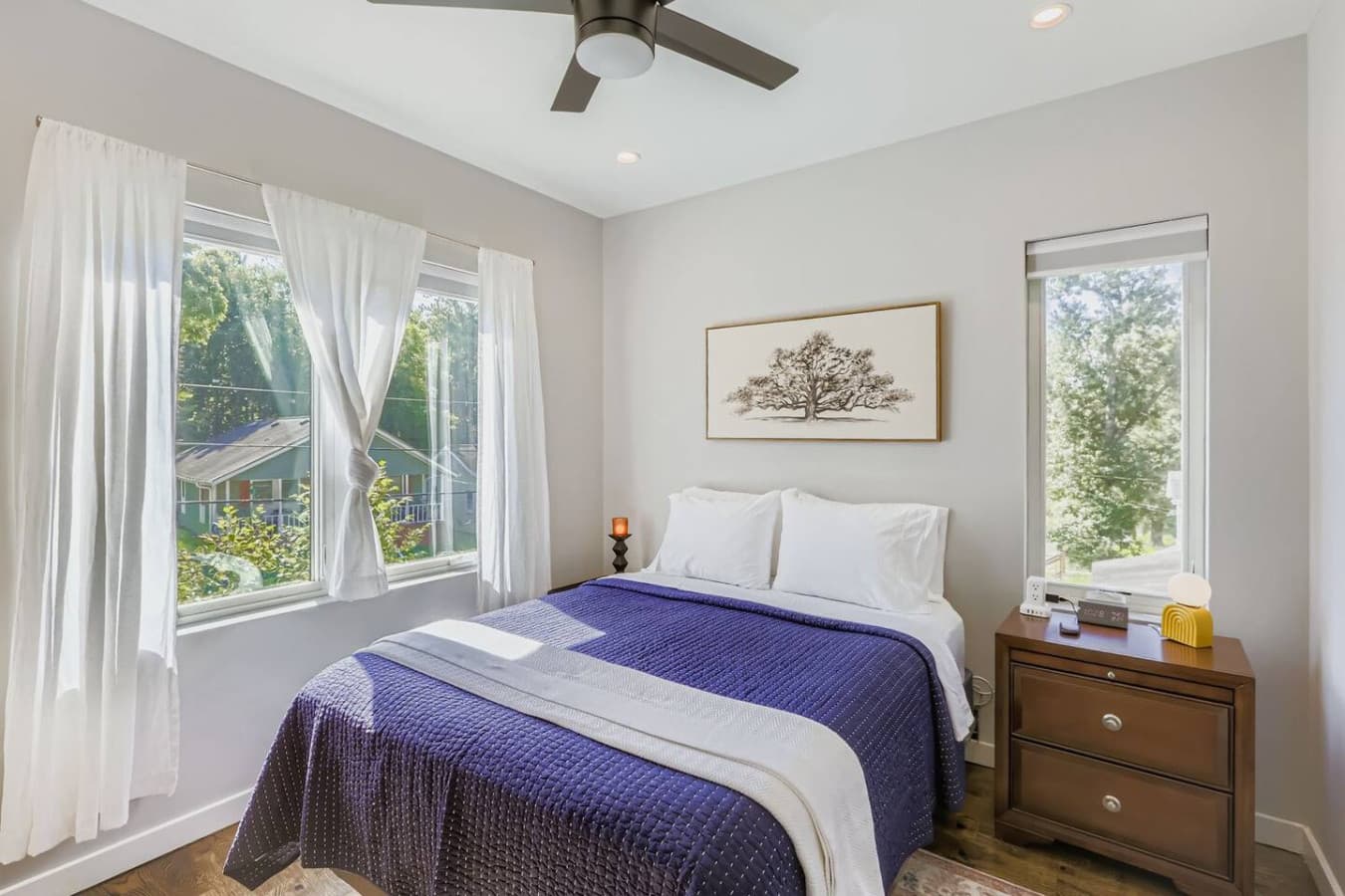 Unit A: Relax in the serene master bedroom featuring a cozy queen bed, Smart TV and ceiling fan.