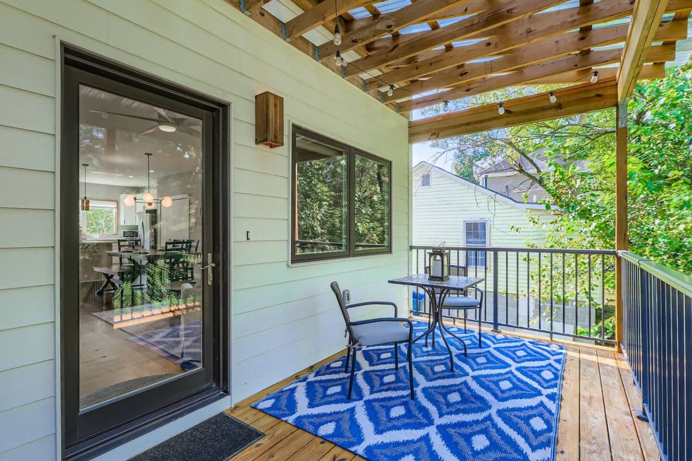 Unit A: Charming covered back porch with peaceful views of the fenced yard and surrounding trees.