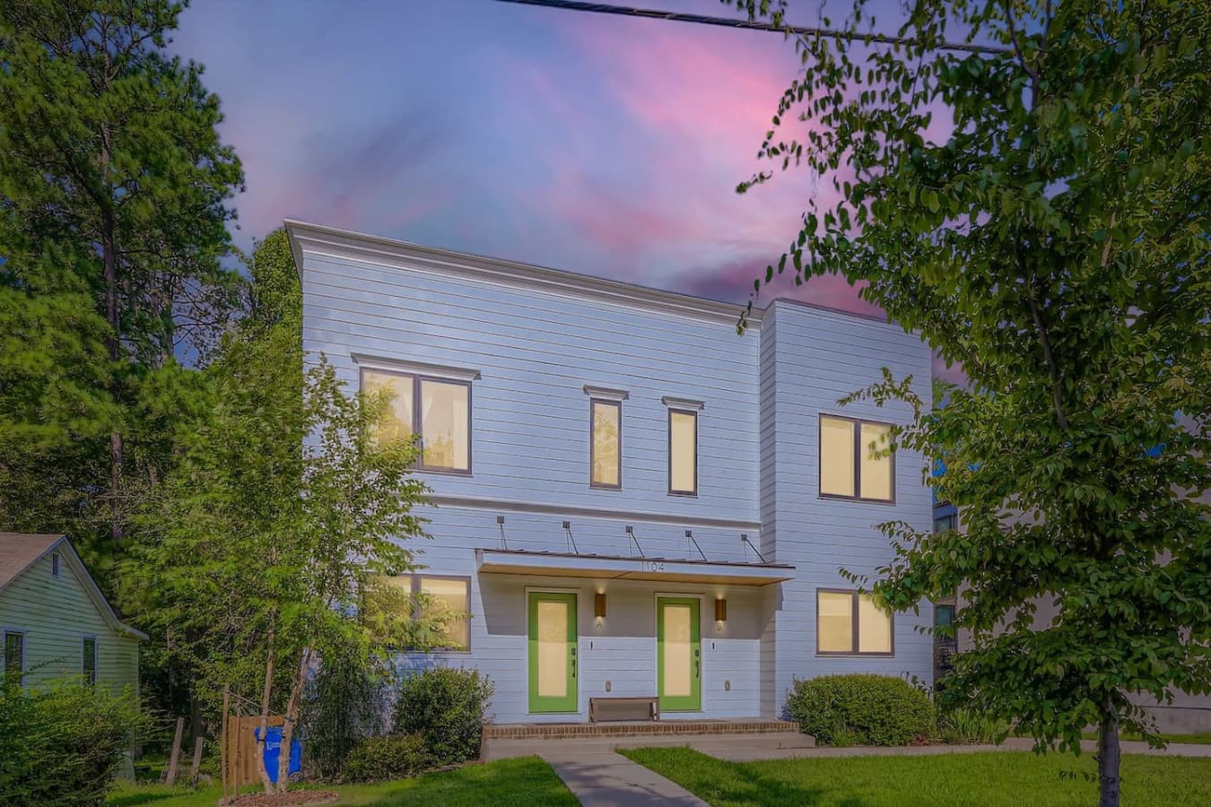 Modern duplex with clean, contemporary design and private entrances for each unit. Featuring fresh landscaping, ample driveway parking, and a fenced backyard.