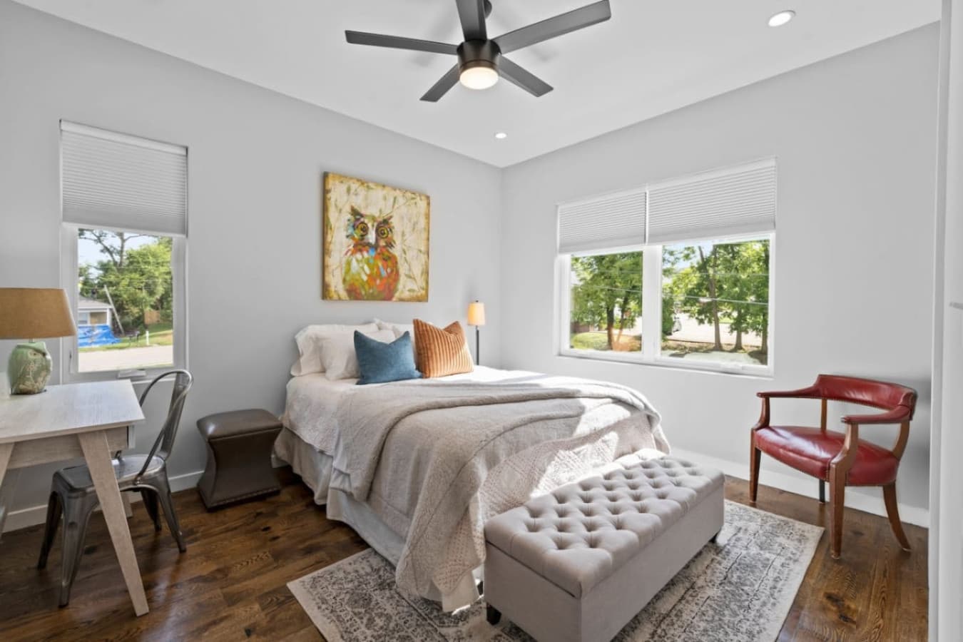 Unit B: Relax in the serene master bedroom featuring a cozy queen bed, Smart TV, ceiling fan, walk-in closet, office desk, storage bench, nightstands, charging dock and white noise machine.