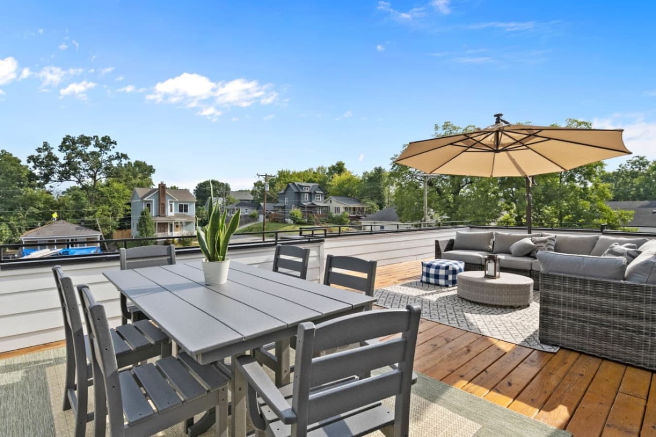 Unit B: Enjoy the spacious rooftop deck featuring stylish dining and lounge areas, complete with a large umbrella for shade and cozy seating for relaxing or entertaining.