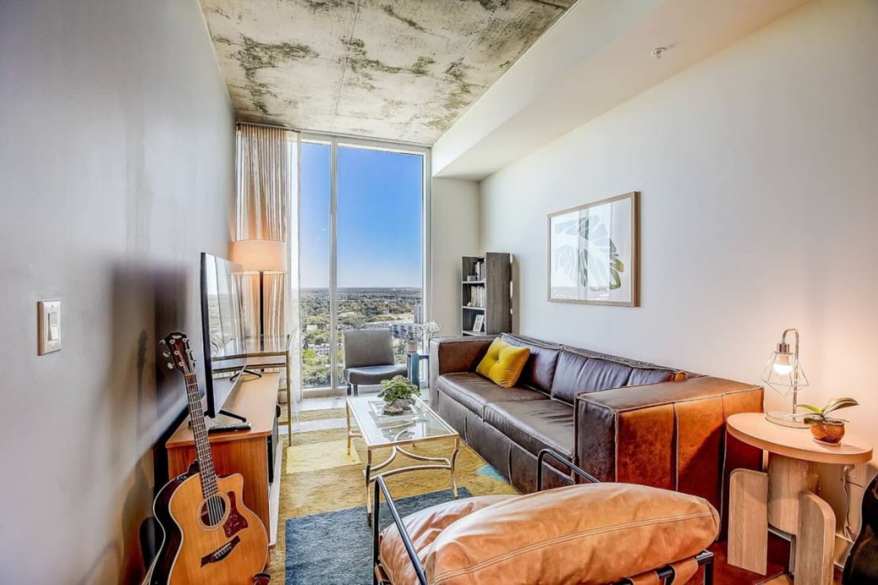 Basking in the warmth of natural light, this spacious living room boasts a stunning view through its expansive window.