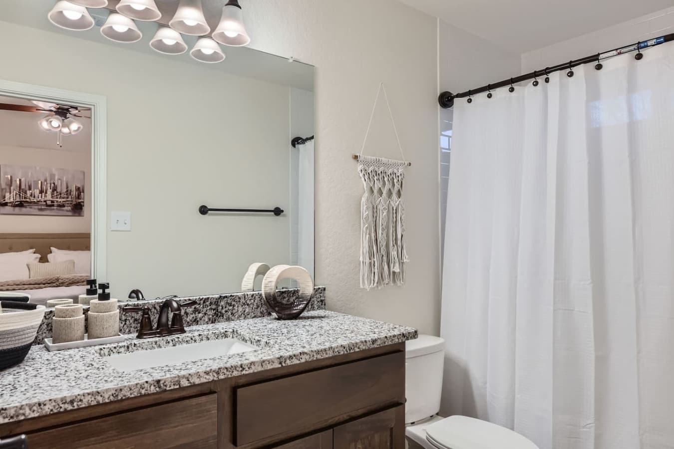 Ensuite master bathroom featuring a tub shower combination.