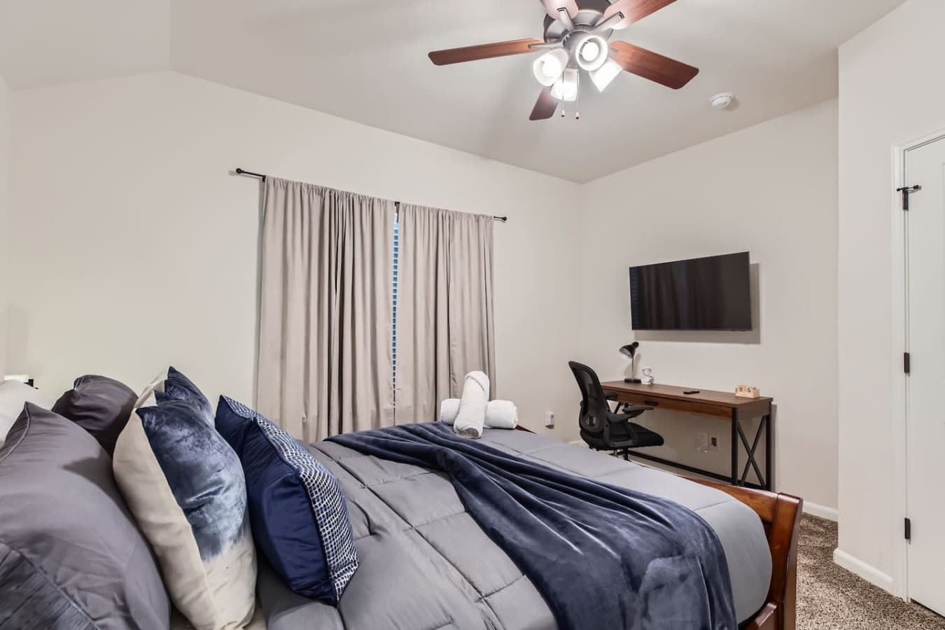 Queen size bed along with a work station and Smart TV for streaming in the third bedroom.