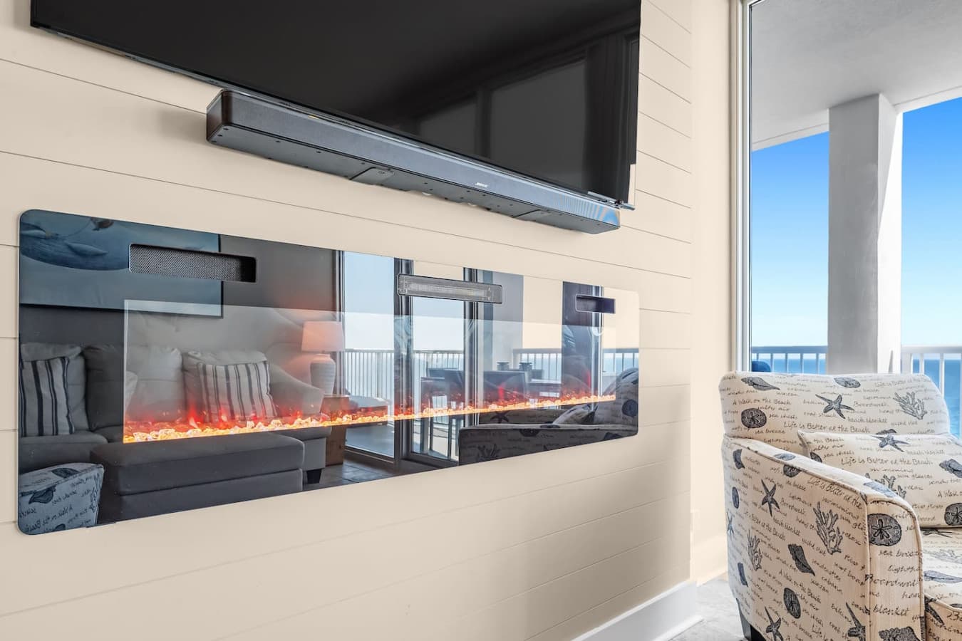 Cozy up by the electric fireplace while enjoying the stunning beach view from the balcony.