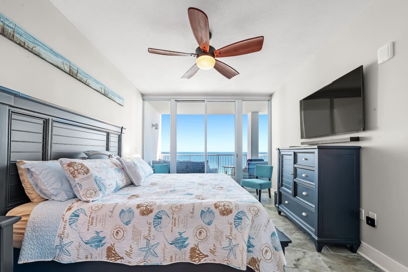 Relax in comfort with a king-size bed and balcony views in the master bedroom.