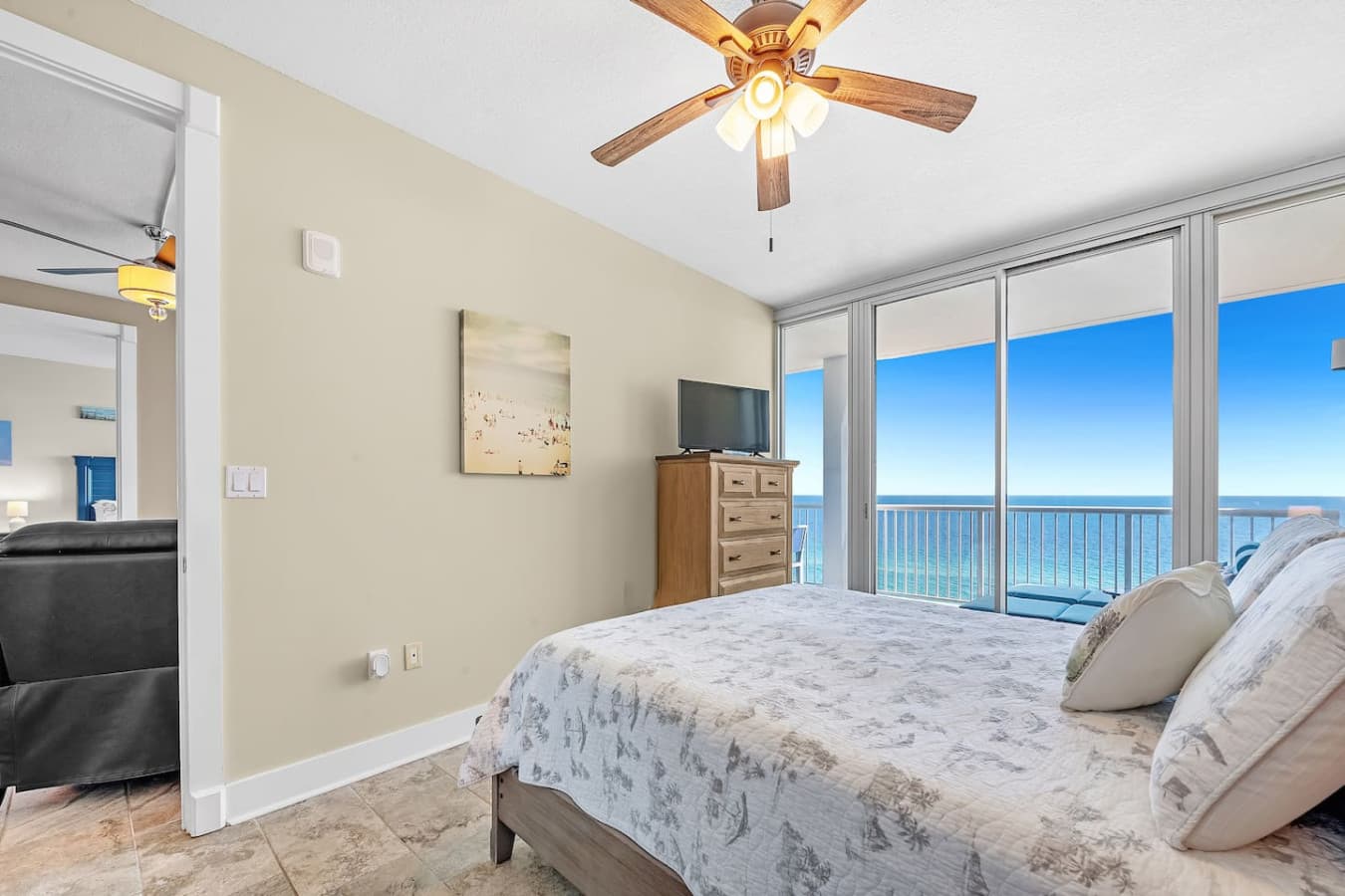 Cozy queen-size bed, TV, and balcony access in the second bedroom.