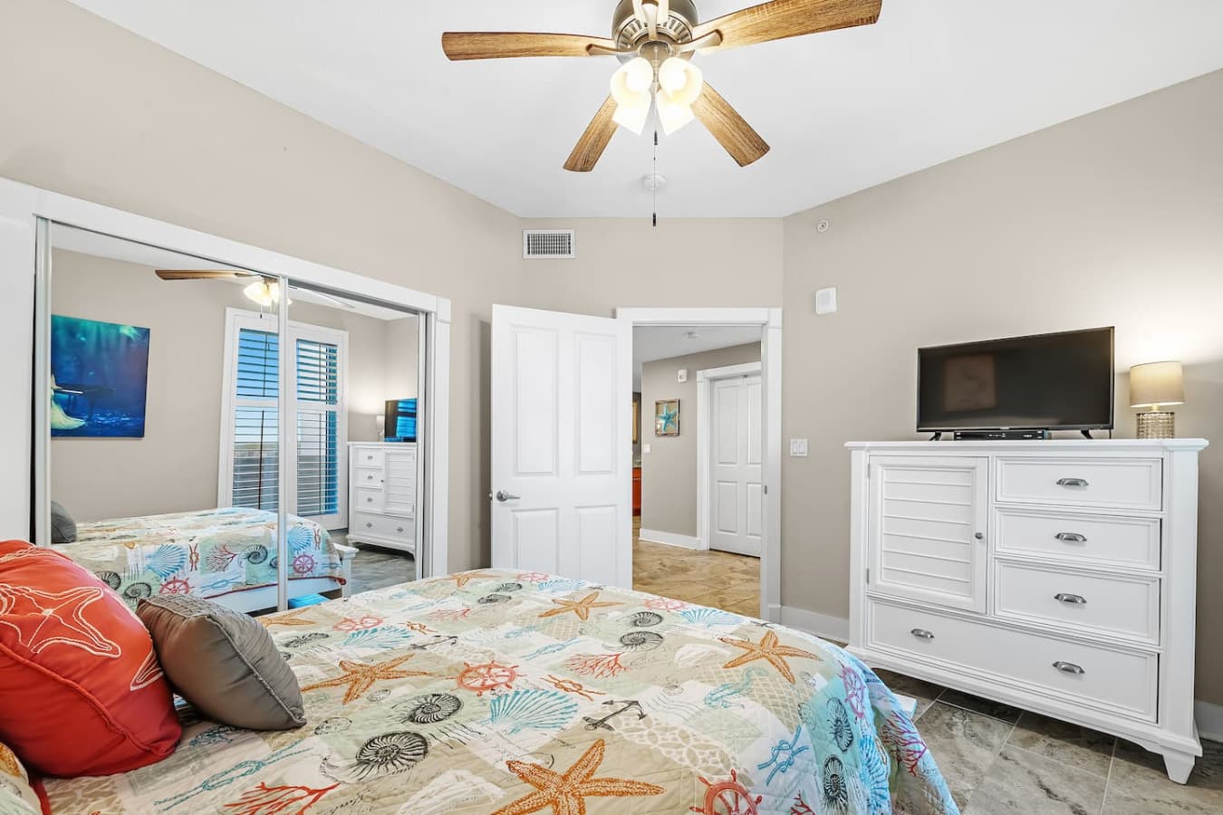 Cozy queen-size bed and TV in the third bedroom.