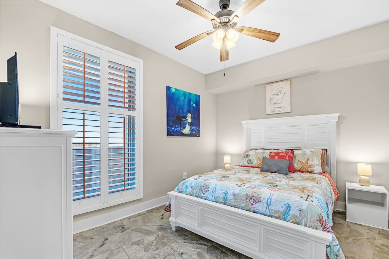 Relax in the third bedroom with a queen-size bed and TV.