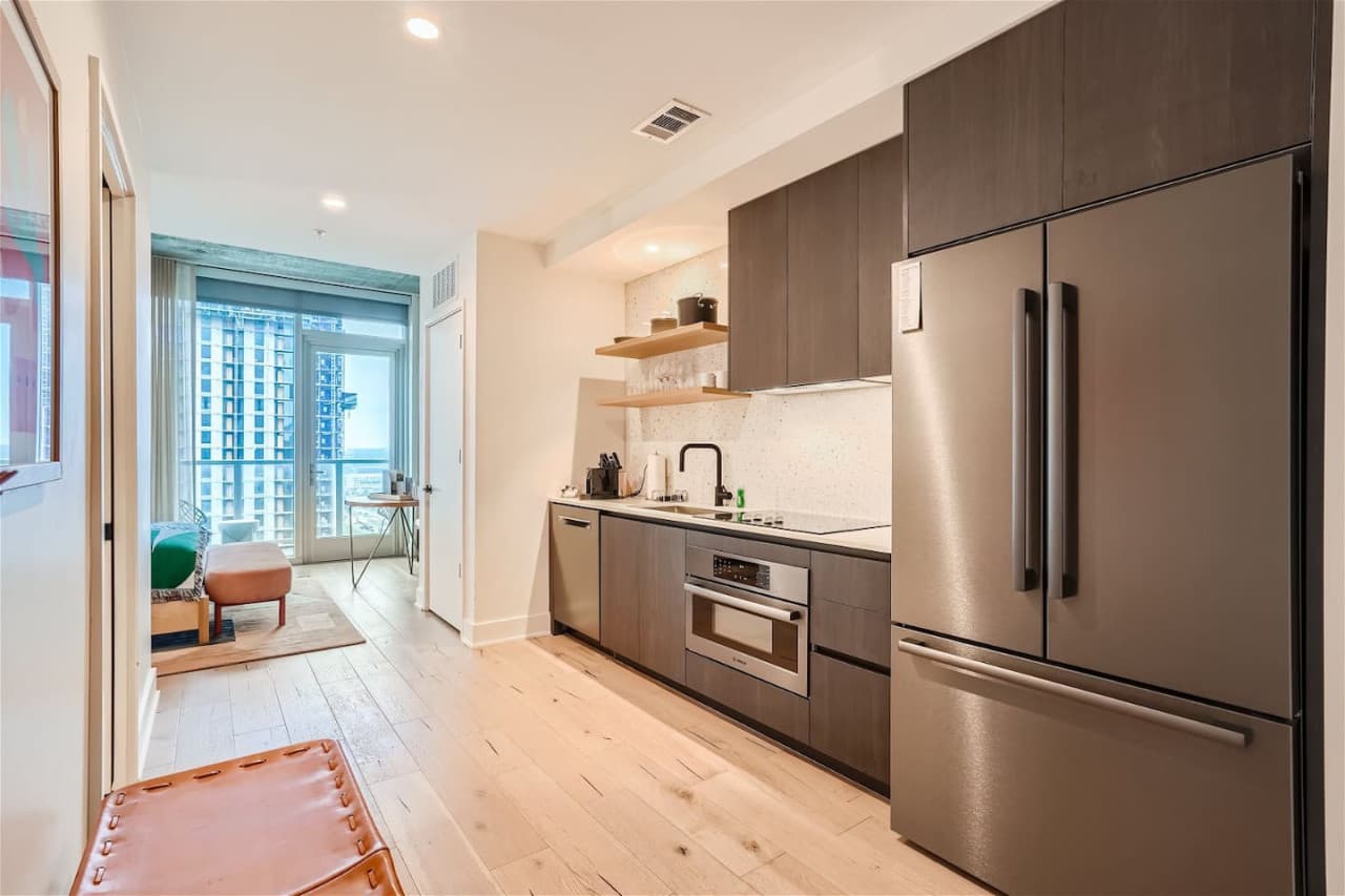 The kitchen stocked refrigerator, microwave, dish washer, toaster, electric range top, Nespresso machine, blender, pots, pans, utensils, knives, glasses, wine glasses, coffee mugs, plates, bowls, salad bowl, paper towels.