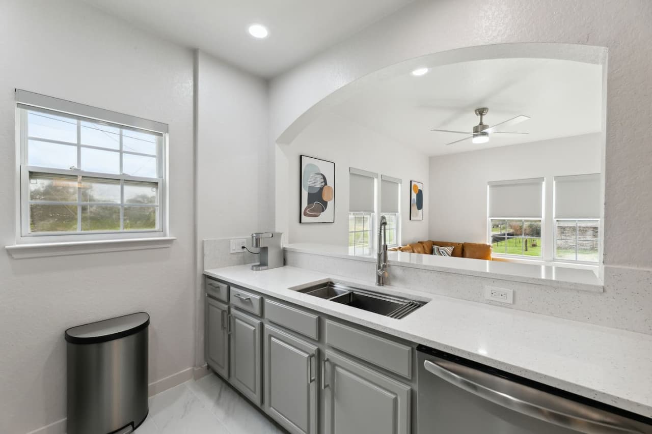 The kitchen is fully equipped with a microwave, toaster, dishwasher, and a Keurig coffee maker.