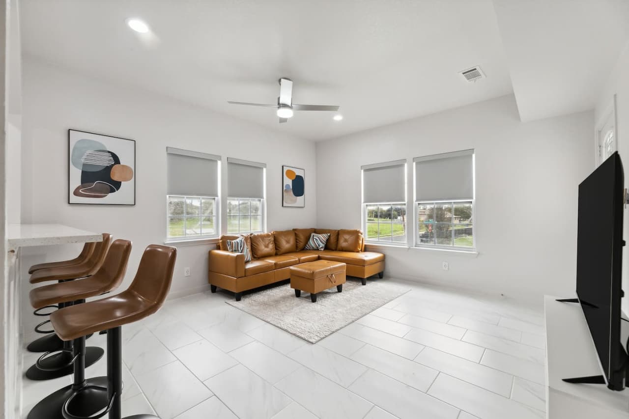 Comfortable leather sectional located in the chic and cozy living room space.