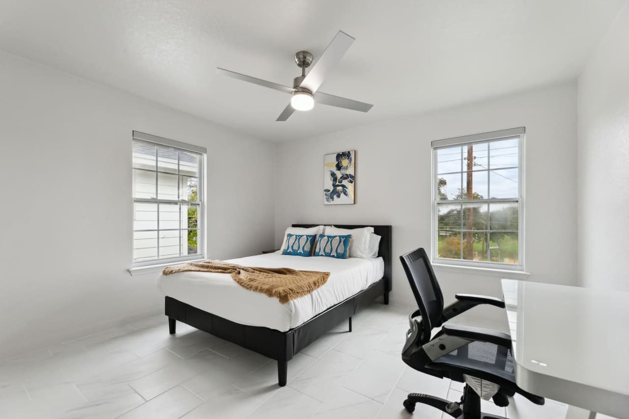 Queen-size bed and work station in the third bedroom.