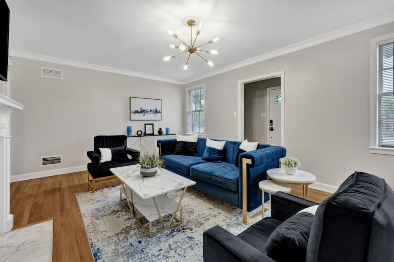 The living room space is a chic, cozy haven designed for comfort and convenience.