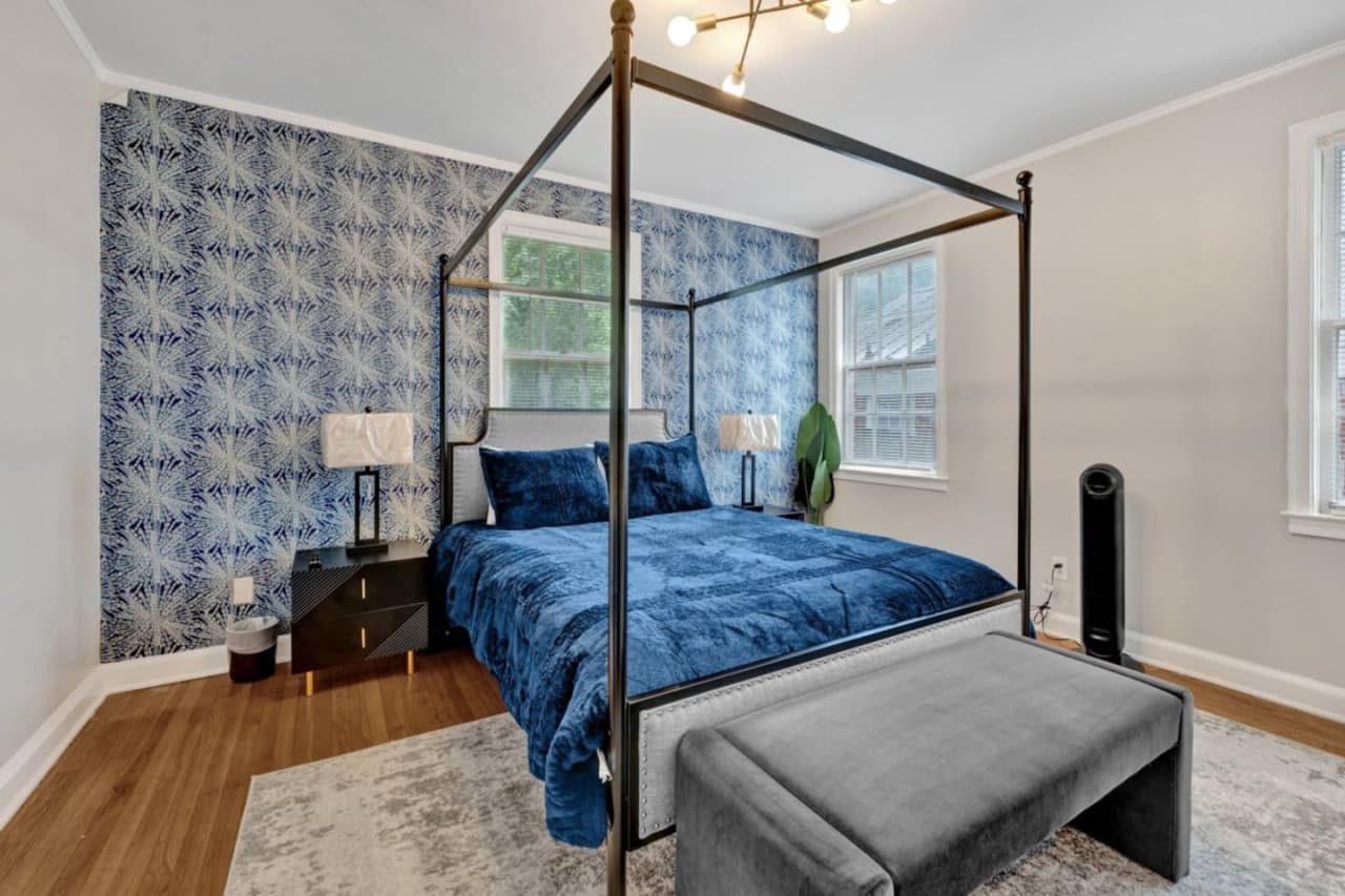 Master bedroom featuring a four-post king-size bed.
