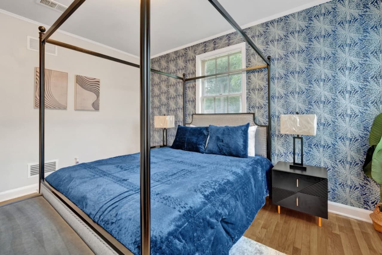 Master bedroom featuring a four-post king-size bed.