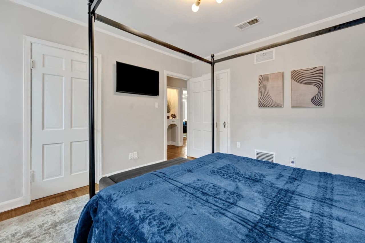 A smart TV for streaming is featured in the master bedroom.