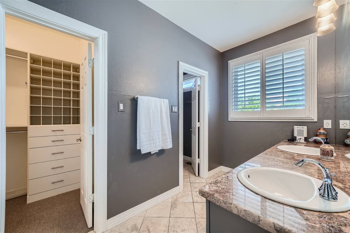 Master bathroom featuring a walk in closet.