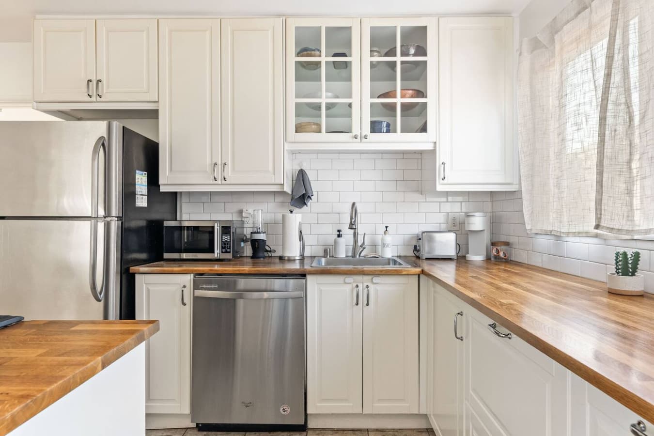 Well stocked kitchen with ample counter space, stainless dishwasher, and everything you need to cook at home.