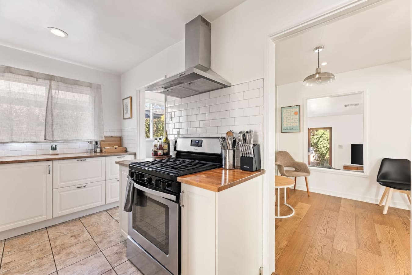 Spacious kitchen layout with modern appliances and clean white finishes.