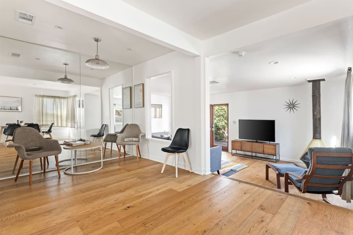 Spacious living area with mid century touches and seamless indoor outdoor flow.