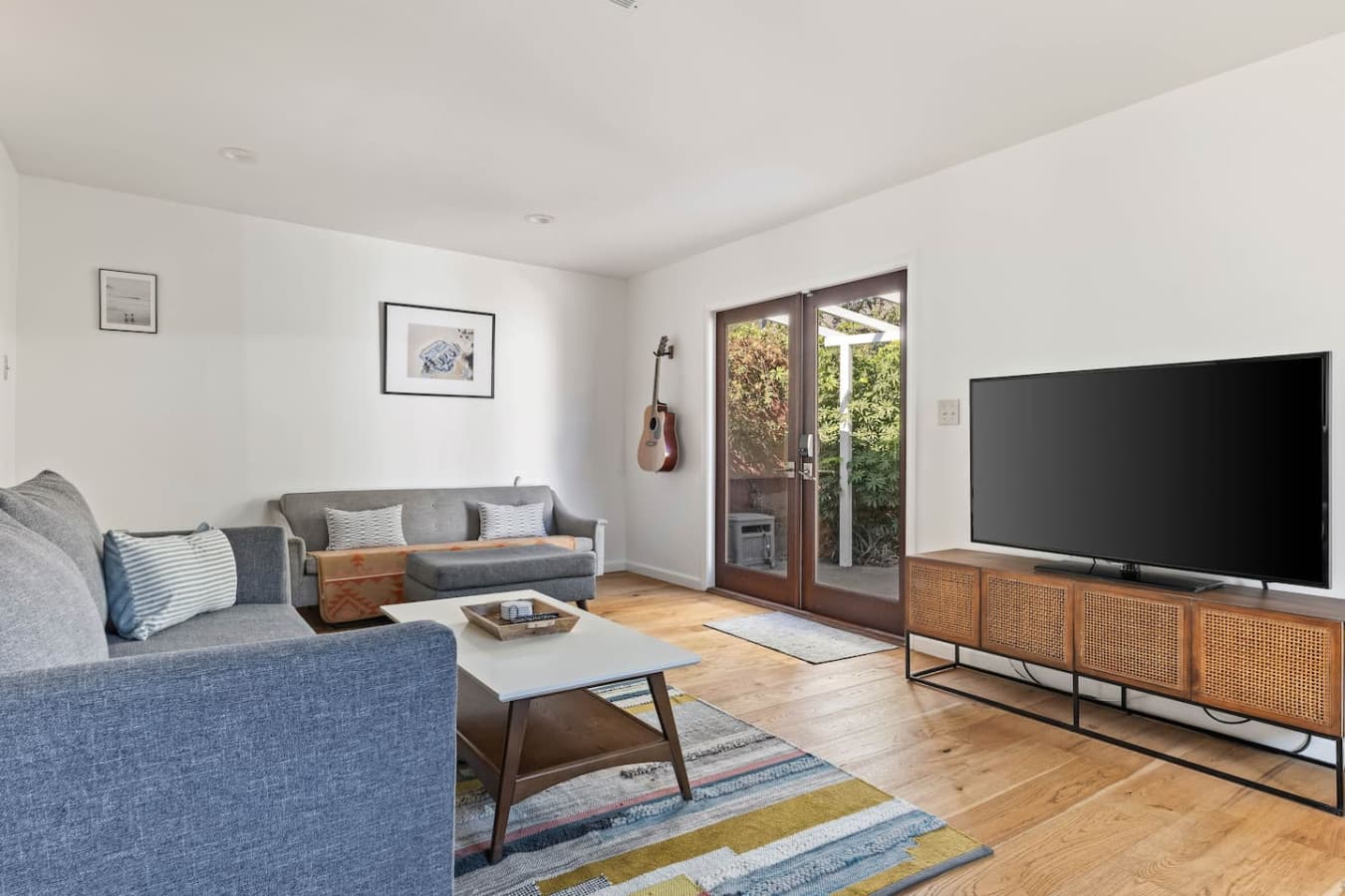 Comfortable lounge space with soft furnishings and direct access to the backyard patio.