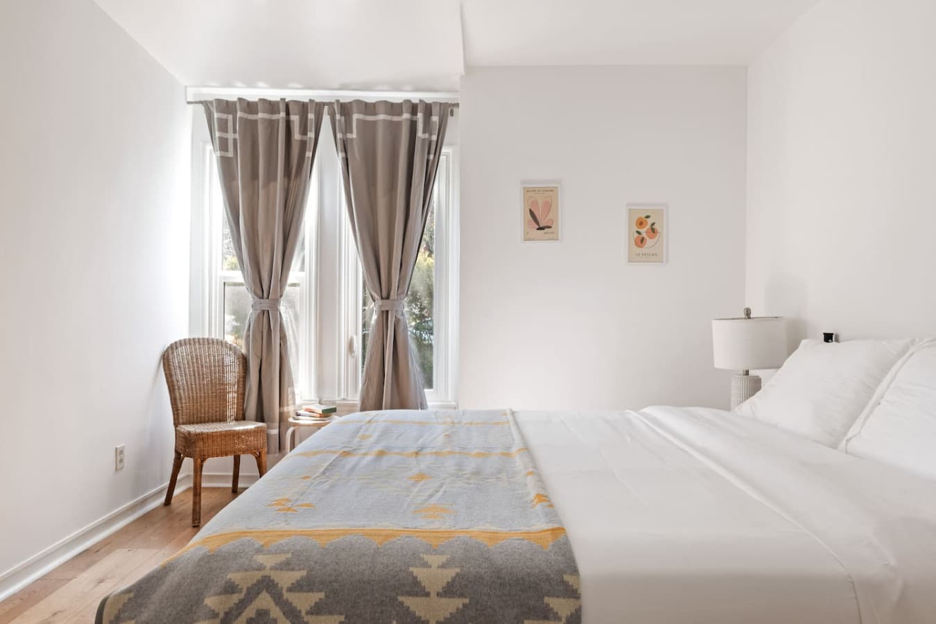 Spacious bedroom with vaulted ceiling and simple elegant decor.