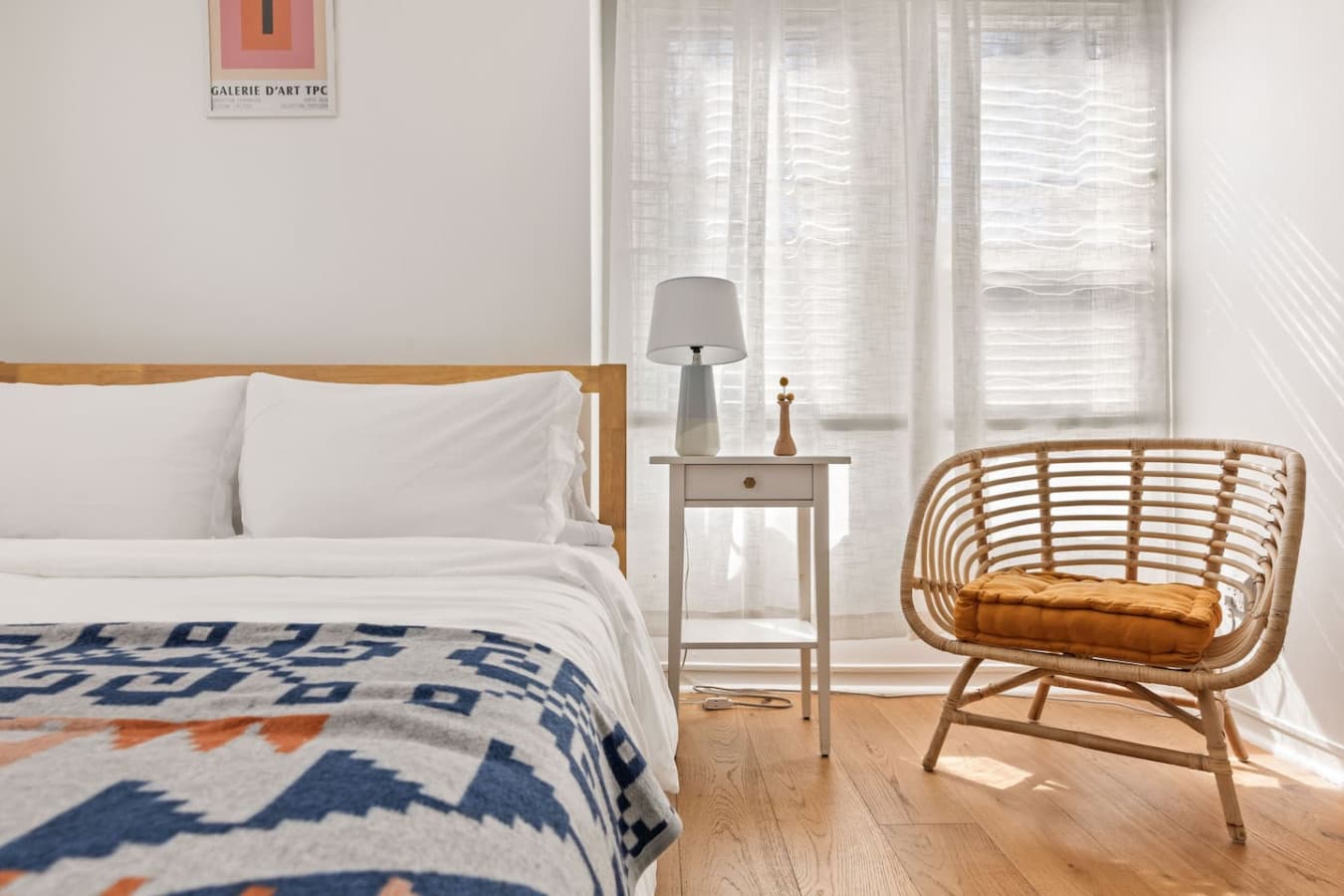 Comfortable sleeping space with soft linens and a cozy corner chair for quiet mornings.