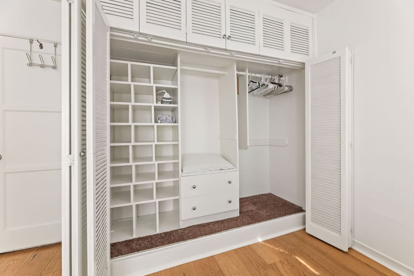 Organized walk in closet with built in shelving and hanging space for extended stays.