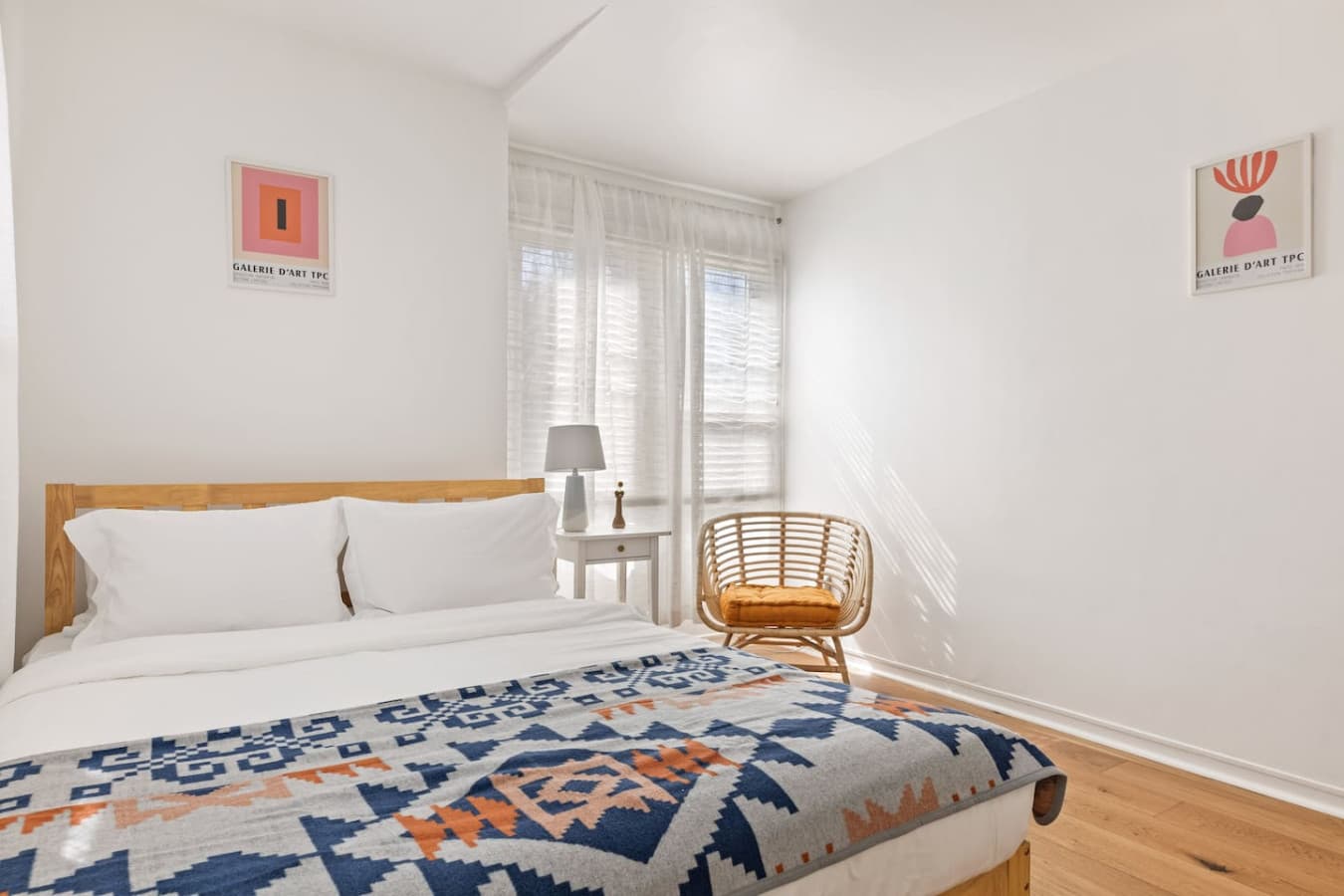 Cozy sleeping space with simple decor and a comfortable low profile bed.