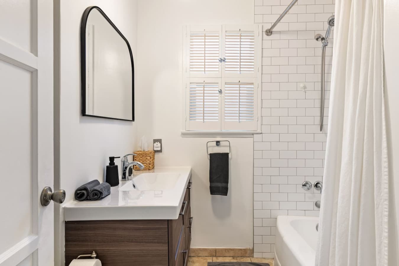 Clean and updated bathroom with subway tile shower and modern vanity.