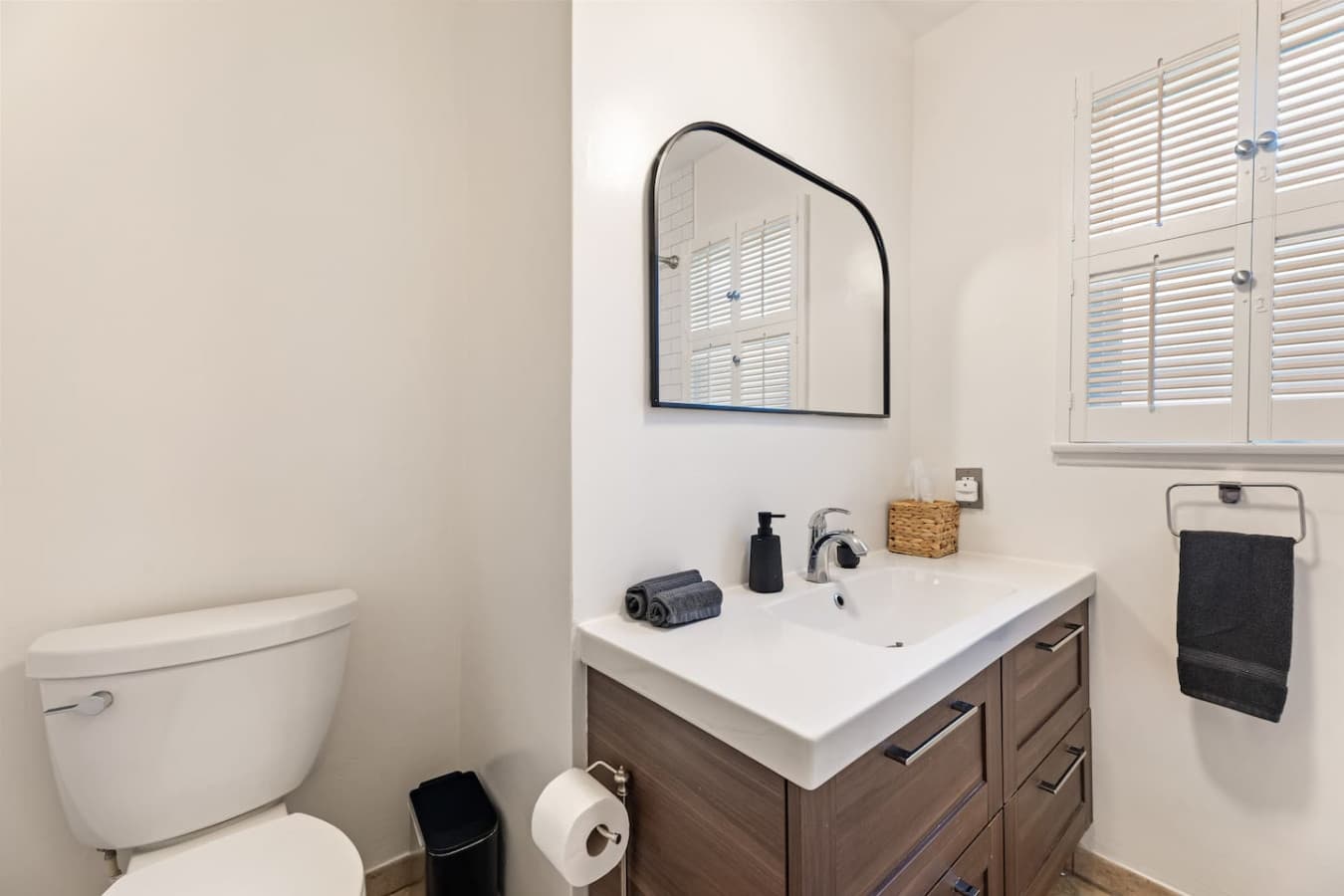 Sleek vanity with contemporary mirror and ample counter space.