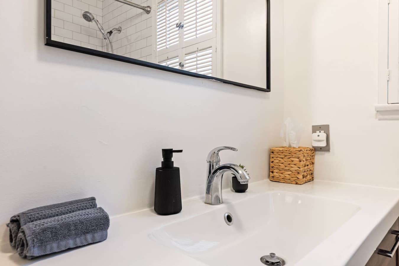 Detailed vanity view with polished chrome faucet and simple modern finishes.