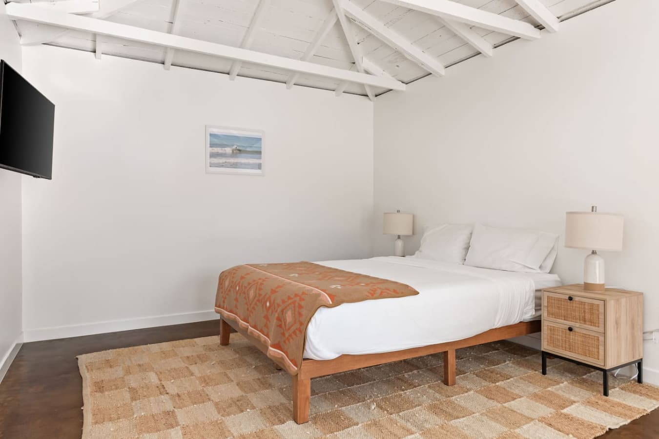 Airy bedroom with vaulted ceilings and a calming neutral design.