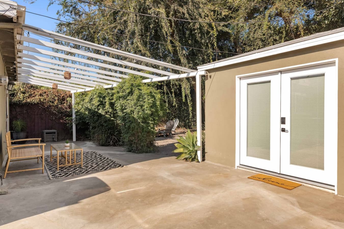 Private outdoor patio with pergola and peaceful garden surroundings.