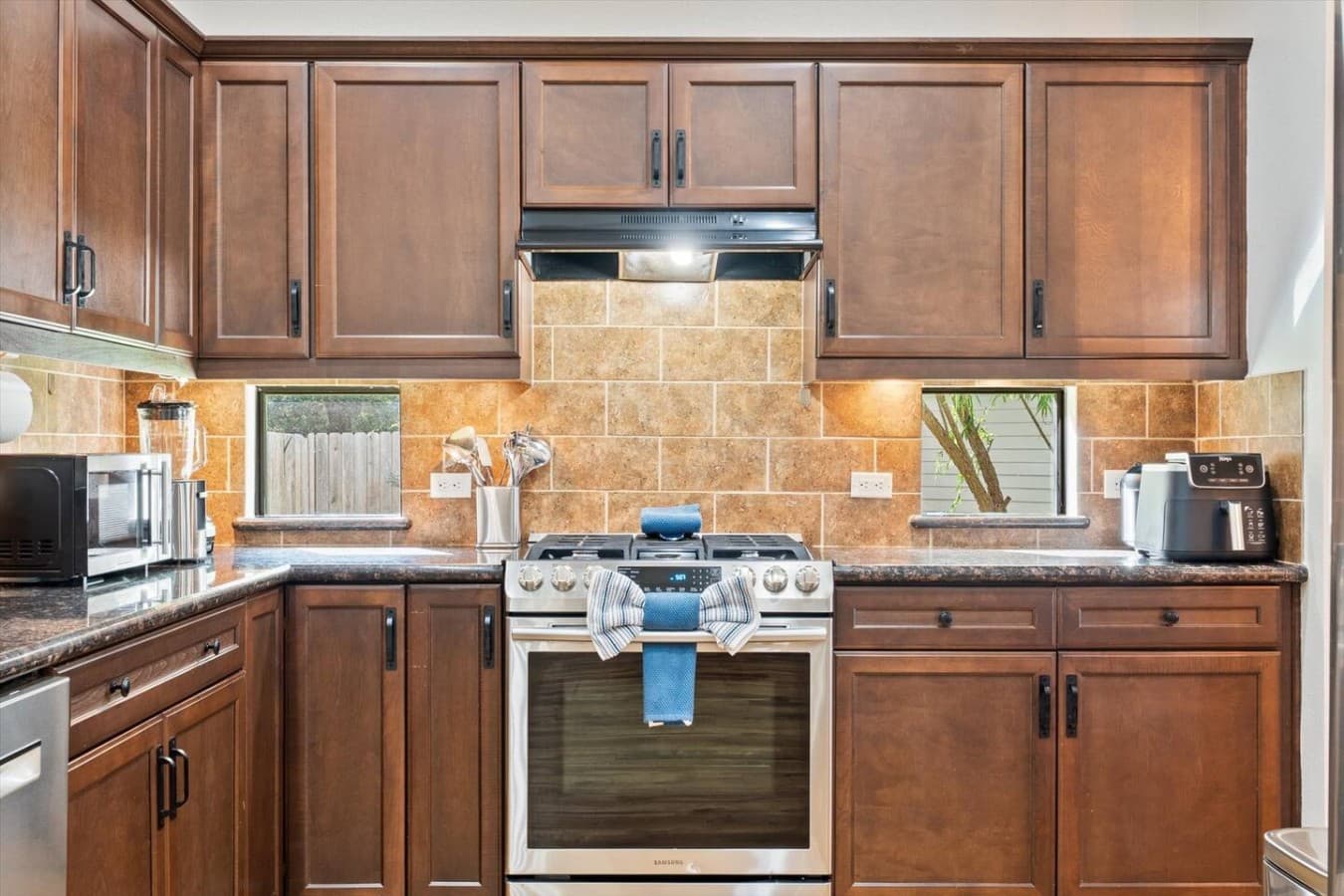 Spacious cooking area with a gas range and ample counter space for meal prep.
