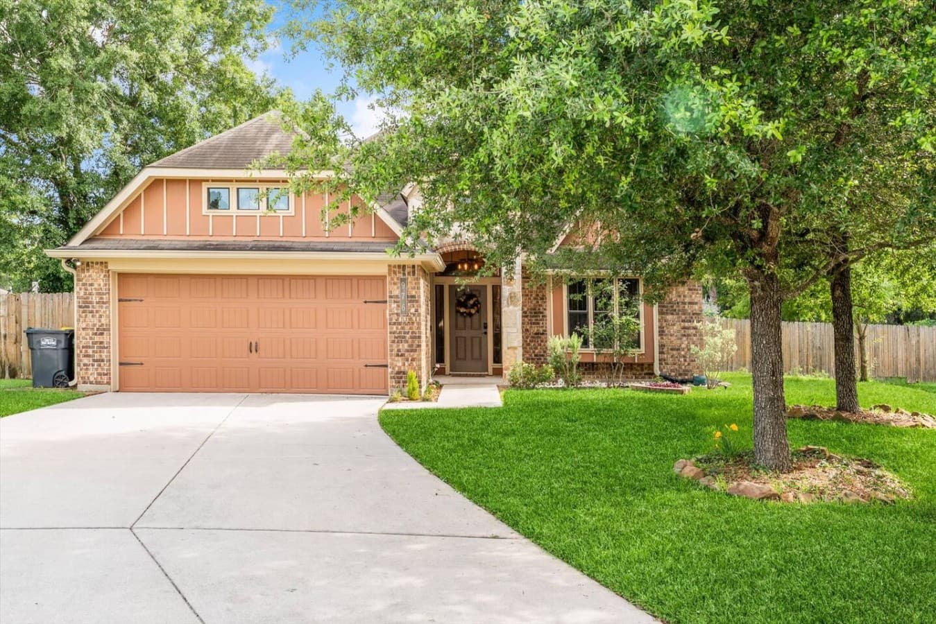 Welcoming front exterior surrounded by mature trees and a well maintained lawn.